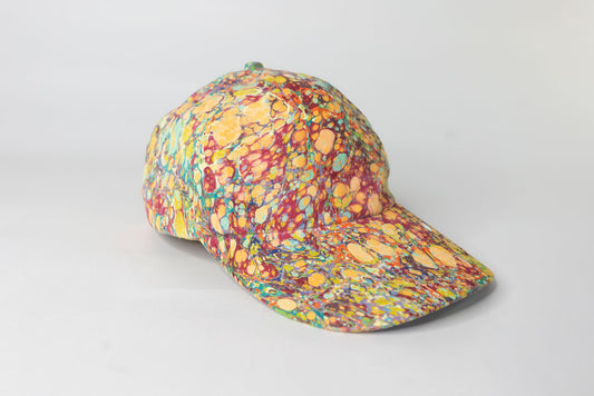 Colorful speckled baseball cap on a light gray background