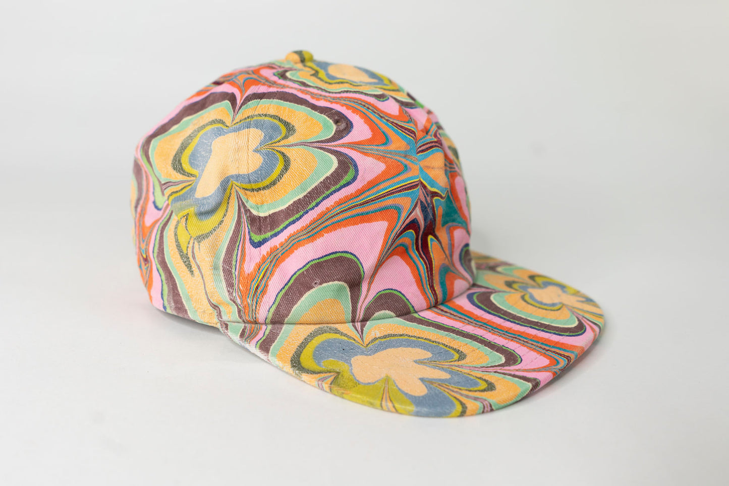 Colorful swirl-patterned cap on a white background